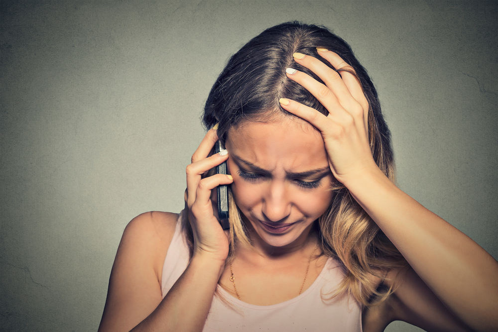 woman frustrated on the phone