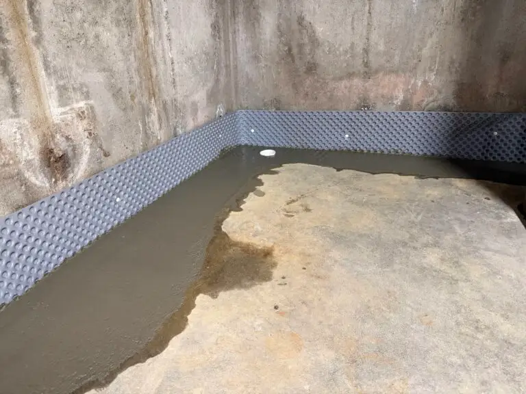 Completed B‑Dry interior drain with cleanout