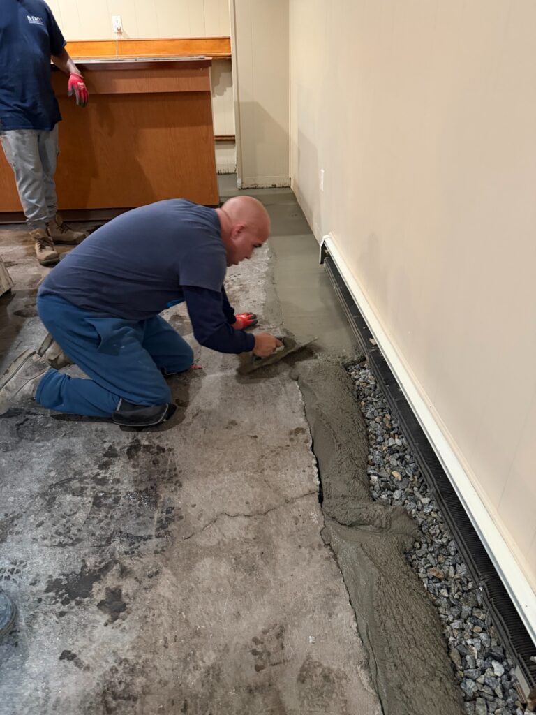 B-Dry installer replacing concrete over an interior drainage system